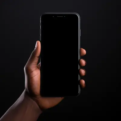 A hand holding a smartphone with a completely black blank screen