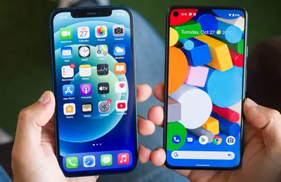 An iPhone and an Android phone held side by side for comparison